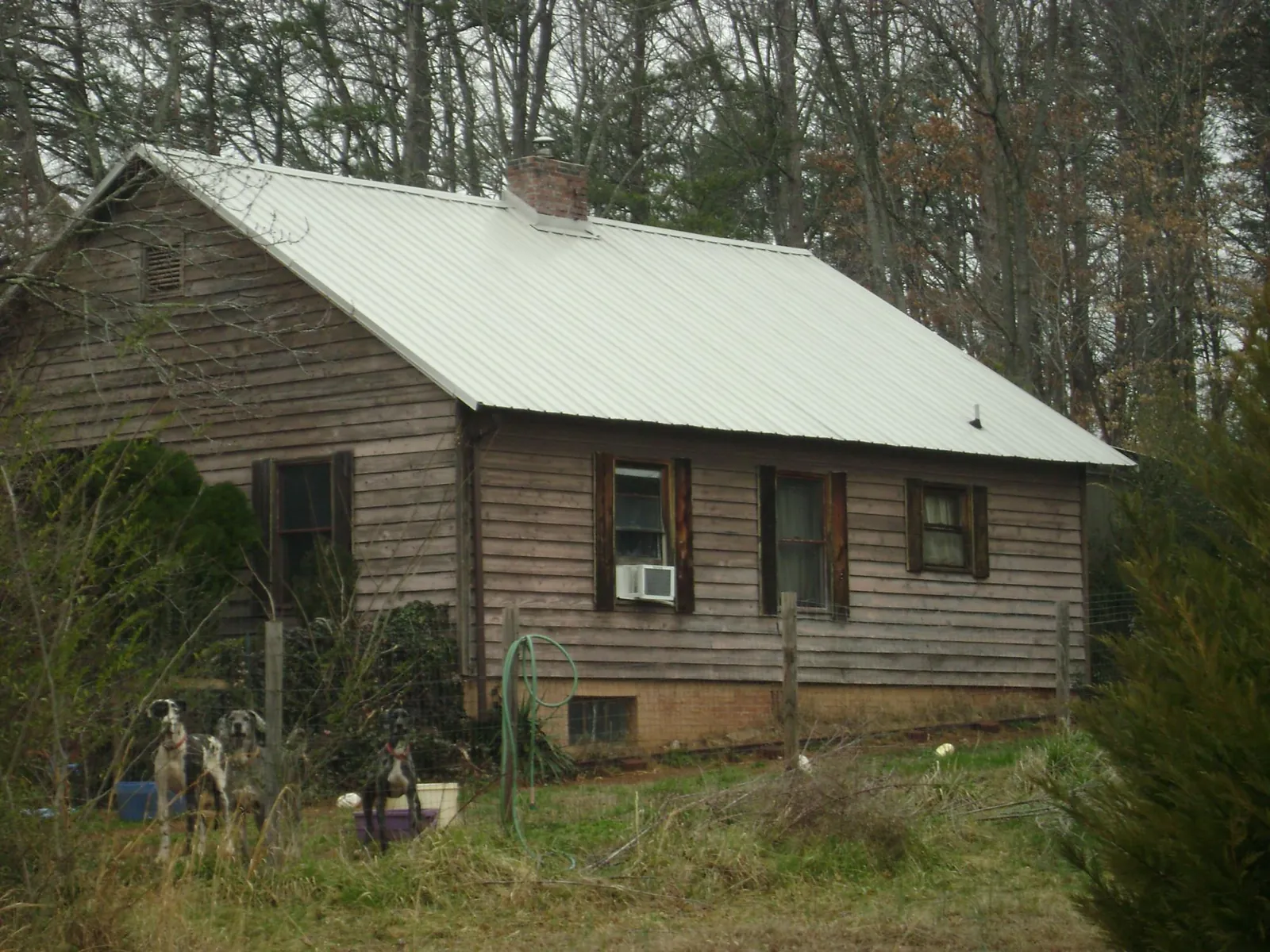 White metal roof on an old wood sided farmhouse, from a Metal Roof Installation job in Seymour
